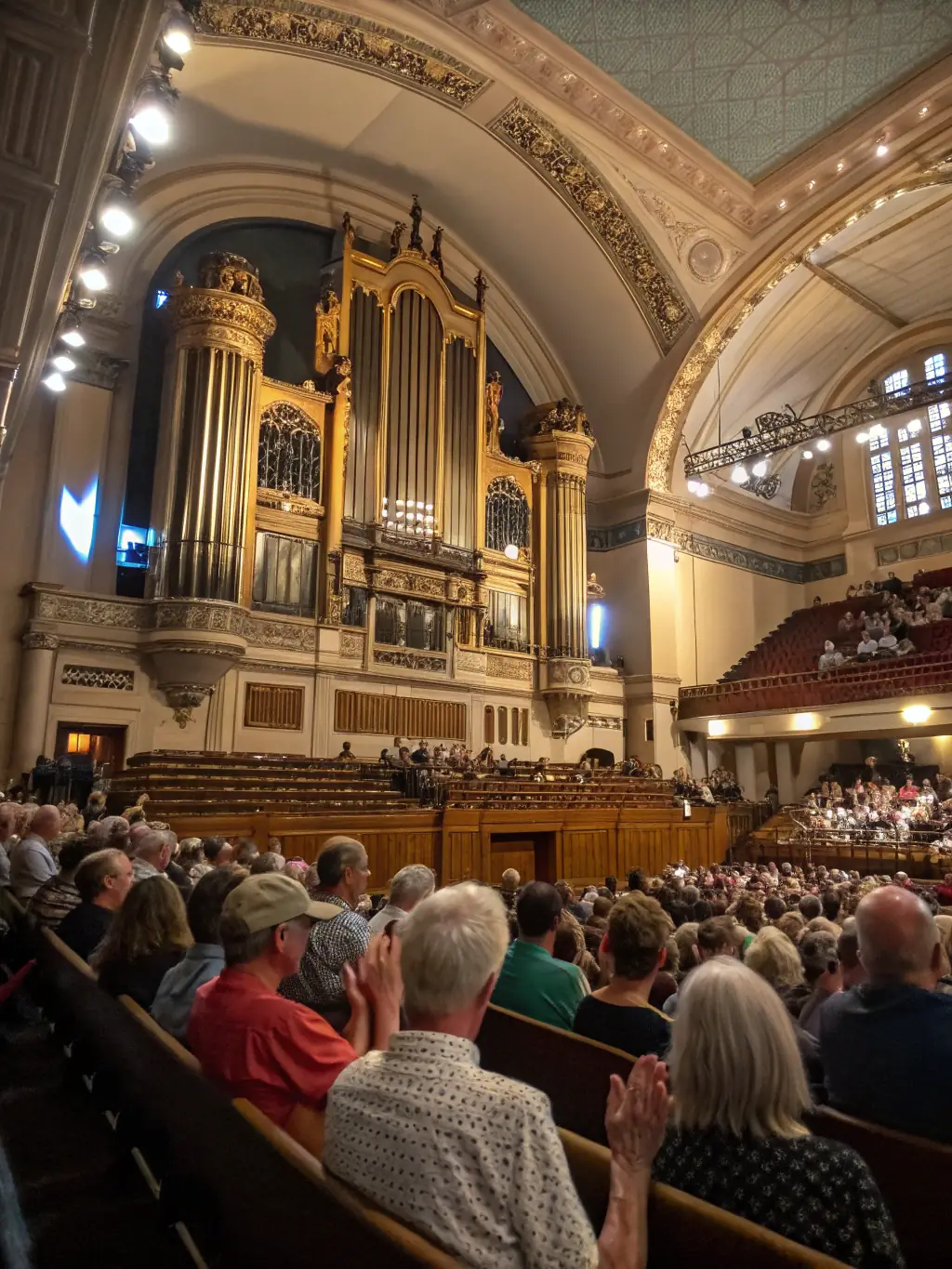A concert hall filled with an audience enjoying a performance of traditional Irish music by a group of talented musicians.